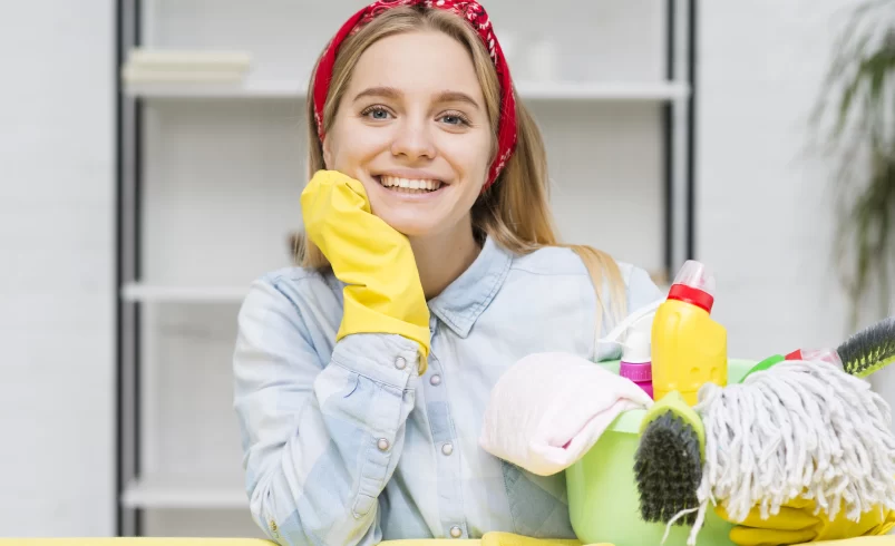 Žena má u sebe čisticí prostředky na úklid